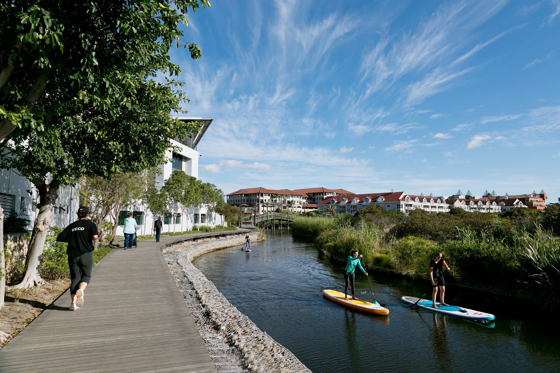 Joggers and paddleboarders along the Century City canal boardwalk, near the start of the Century City Parkrun
